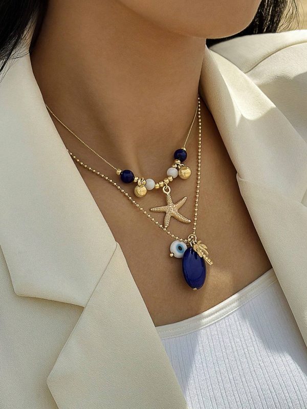 pieza de collar multicolor de varias capas con colgante de ojo de aceite que gotea en forma de árbol de coco y estrella